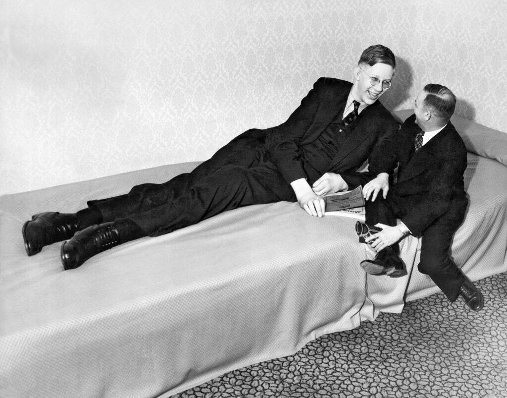 robert wadlow lying in bed chatting with a friend