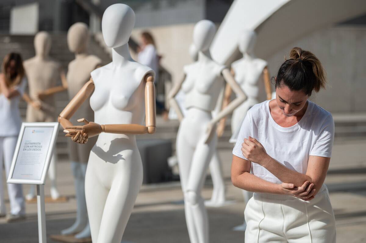 A performer showing pain surrounded by a multitude of...