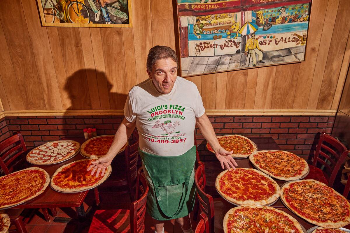 Owner Giovanni Luigi and all his pizza at Luigi's Pizza in Broo