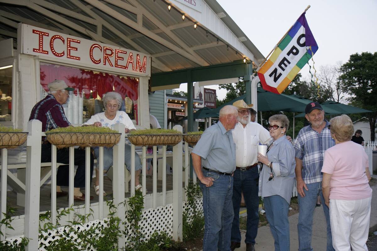 People gathered in front of an ice cream parlor at Courthouse Square.