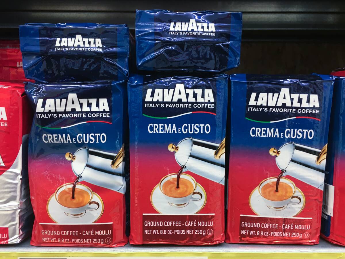 Packs of Lavazza powdered coffee stacked on a shelf. Luigi...