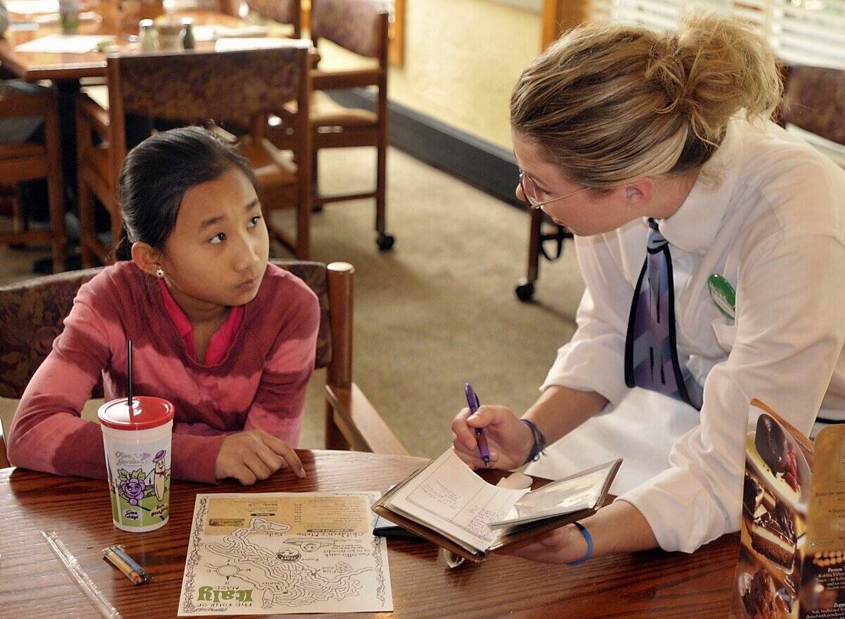 Kyaelinna Pomtay, 12, gives her order to server, Miriah Holmes as ELL King Middle kids have lunch at