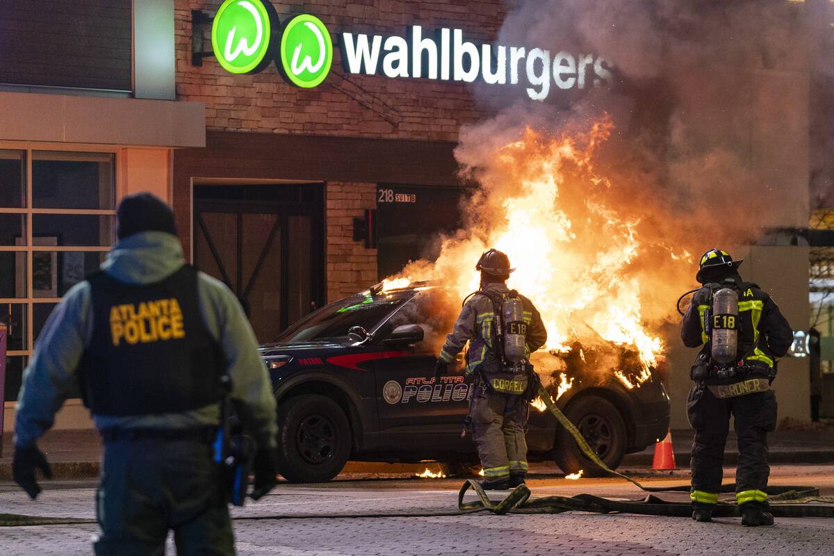 ATLANTA, GA - JANUARY 21- Firefighters are seen in front of a b