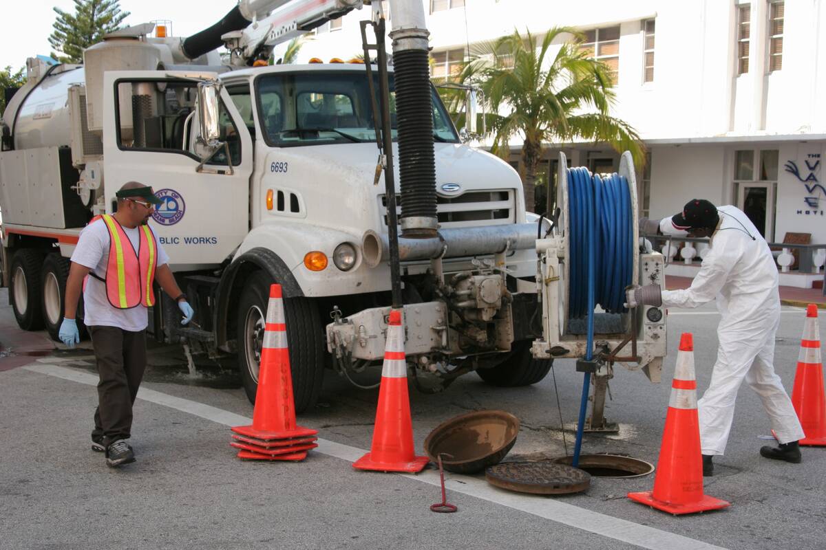 City Public Works pumping vehicle employees cleaning sewers on Ocean Drive.
