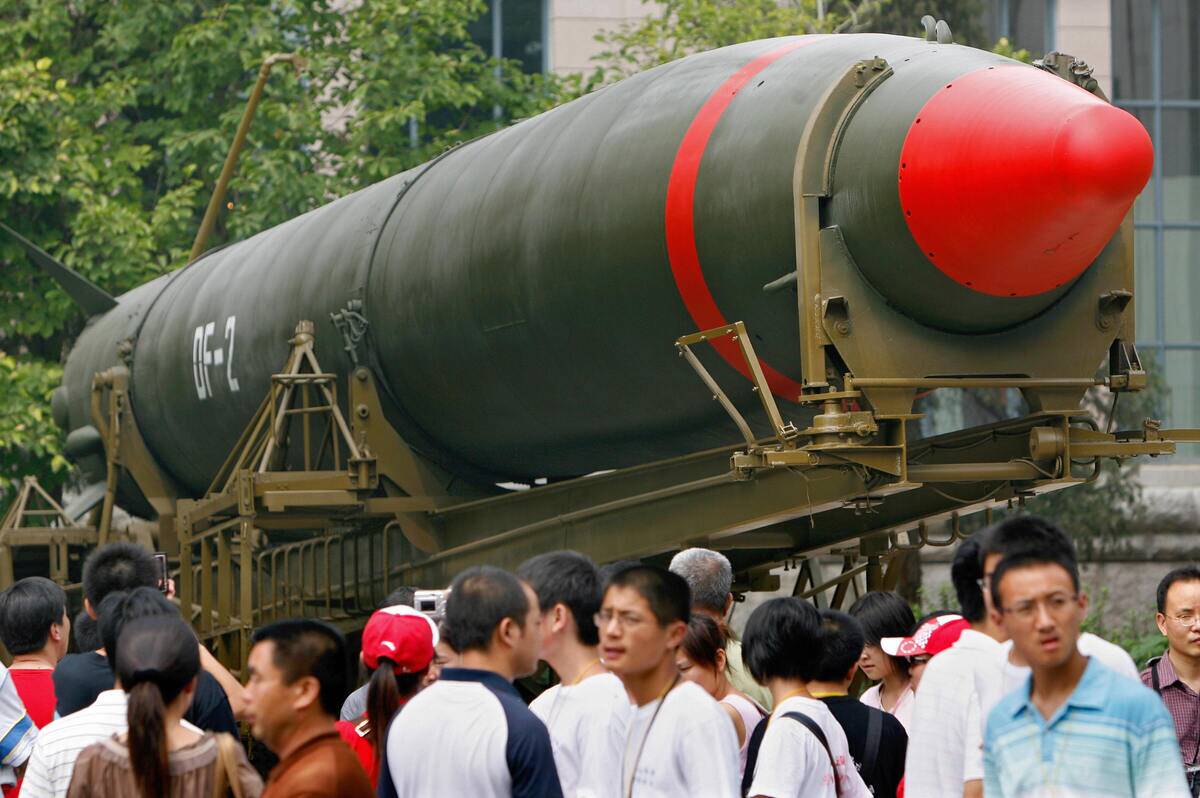 Visitors walk past China's second nuclea...