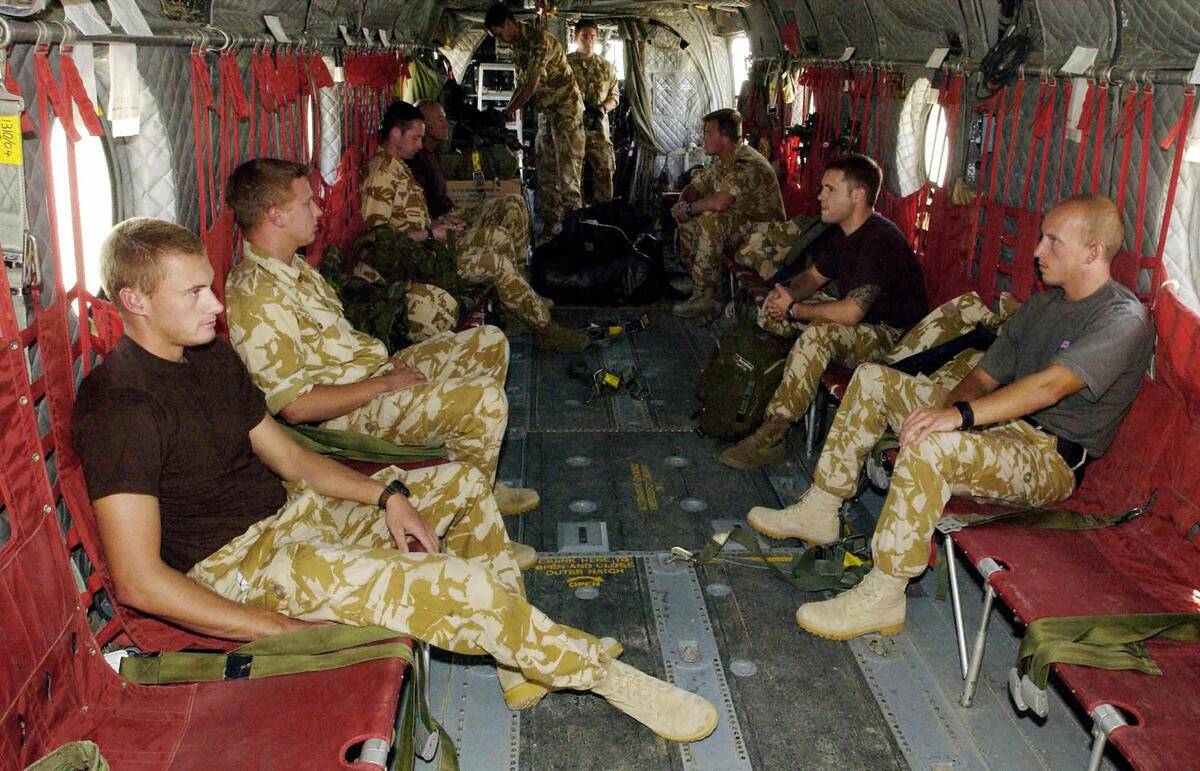 British servicemen sit onboard a militar