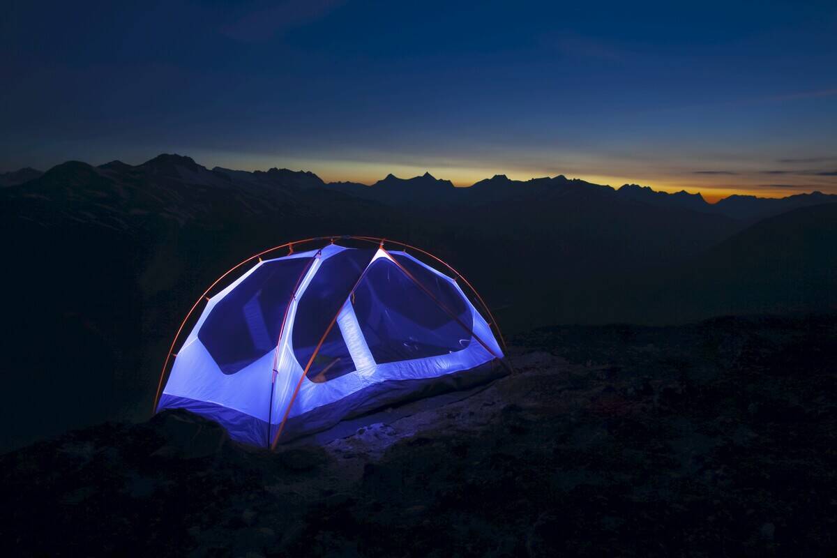 Light Painting A Backpacker Tent High On Mountaintop At Sunset; Skagway, Alaska, United States Of America