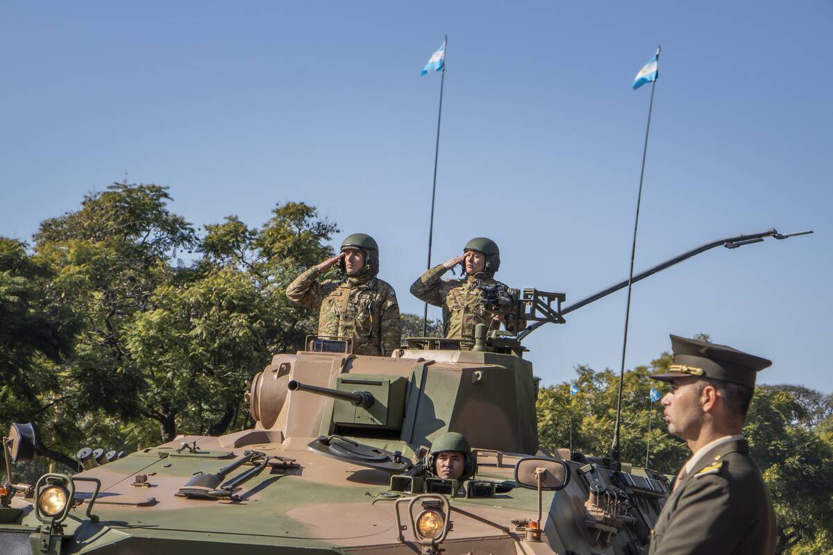 Military personnel give the official salute to President...