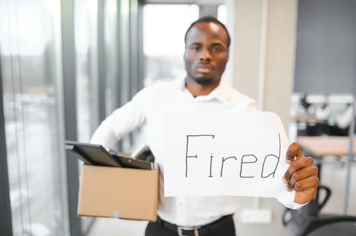 young-african-man-fired-holding-box-with-personal-2024-01-16-18-53-56-utc