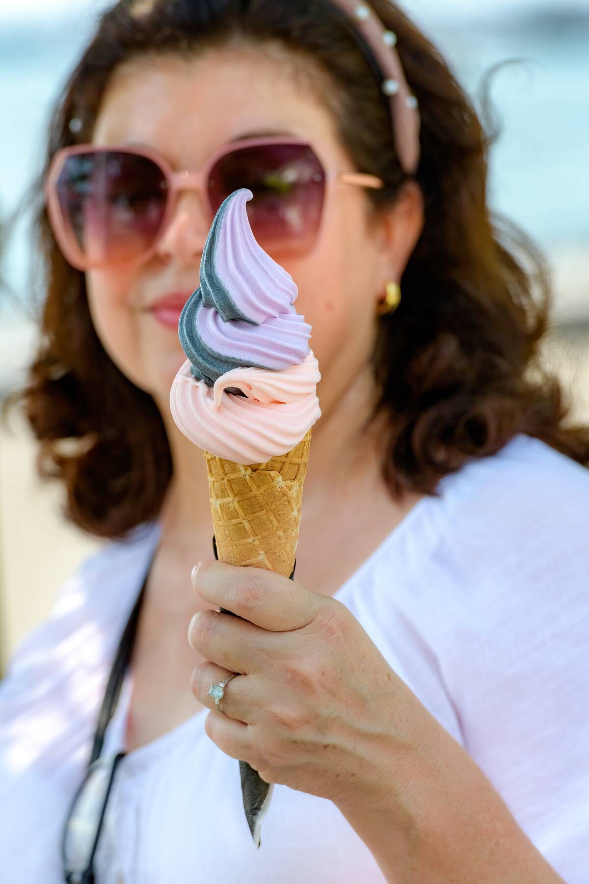 Latin American woman holding an ice cream cone during Summer...