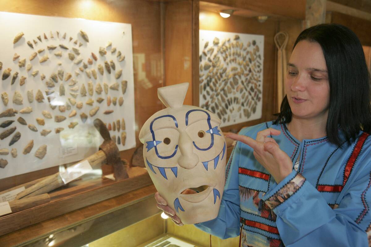 A Cherokee Native American female holding a ceremonial mask in the Oakville Indian Mounds Park and Museum.