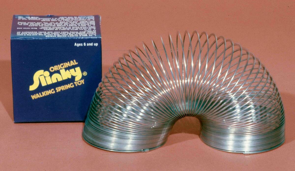 A Slinky is a precompressed helical spring toy invented by Richard James in the early 1940s