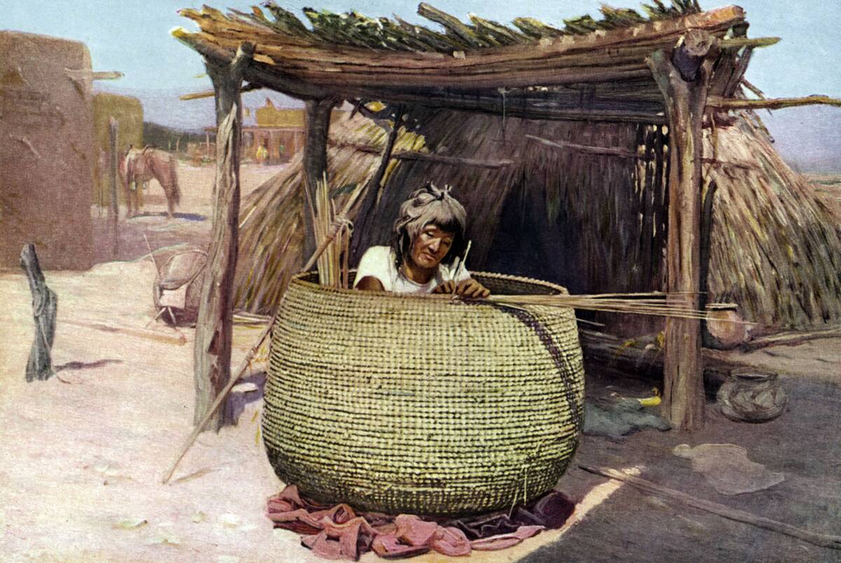 Native American Apache woman - weaving a granary (a large supply basket to store grain and vegetables).