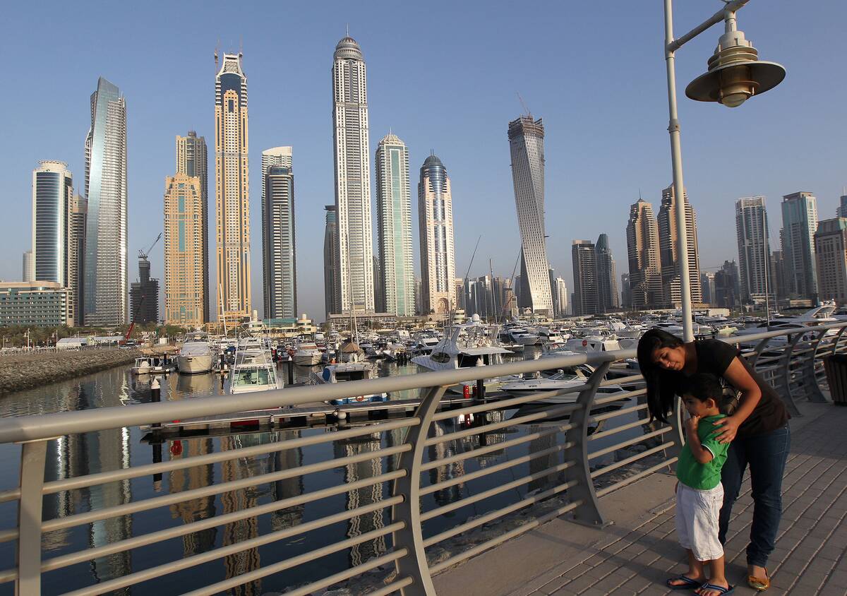 A woman and child stand opposite Dubai's