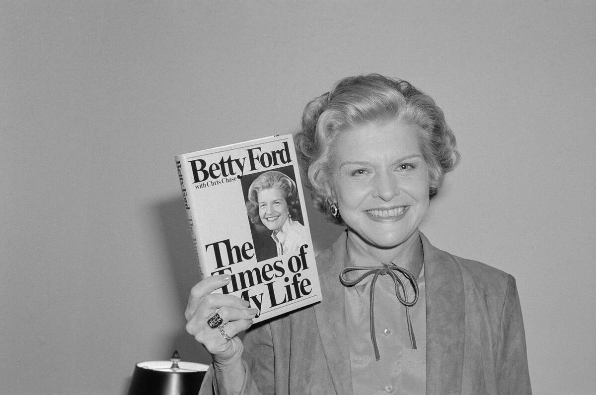 Betty Ford Holding up Her Book