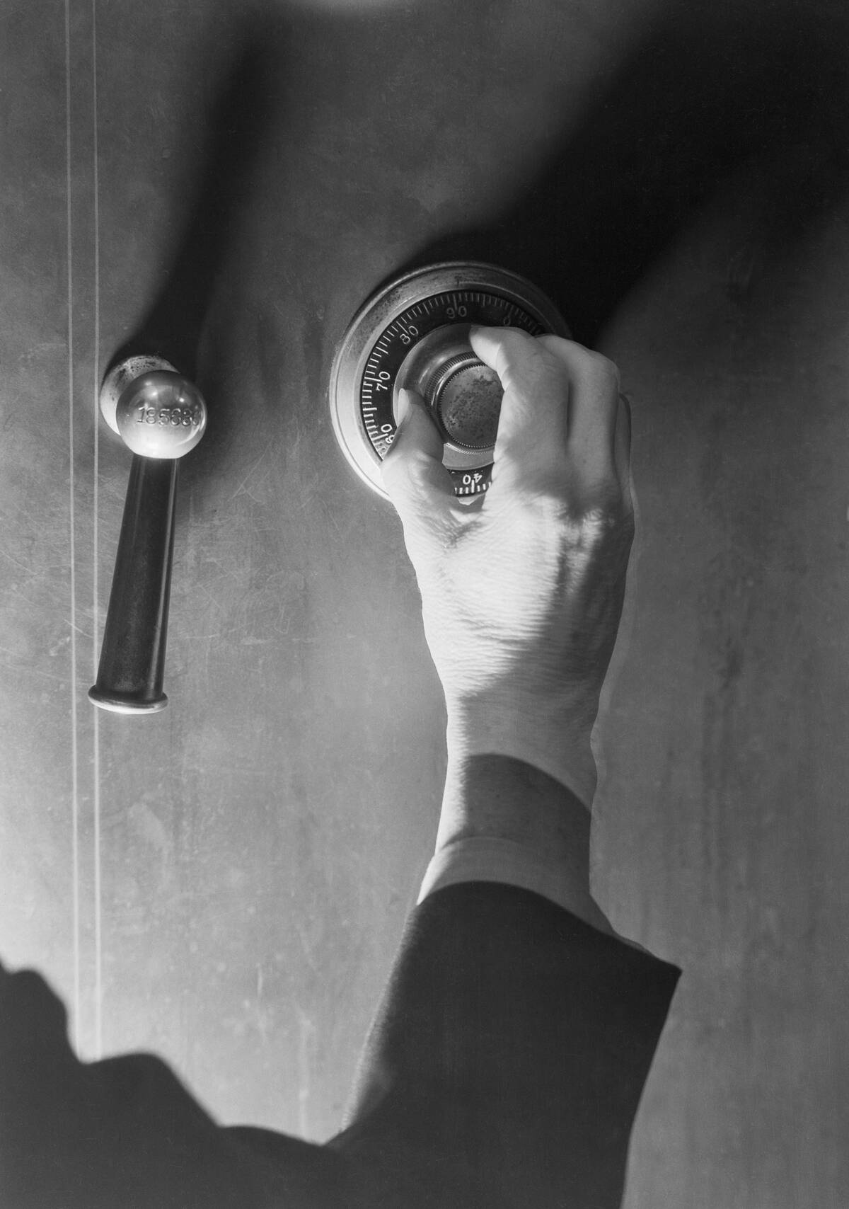 Close-Up Of Hand Opening Safe