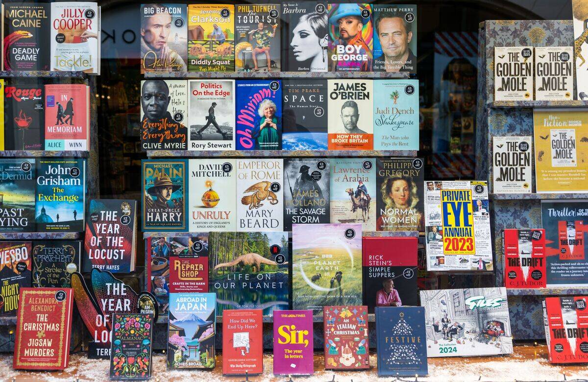 Display of best selling books in shop window, Waterstones, Ipswich, Suffolk, England, UK