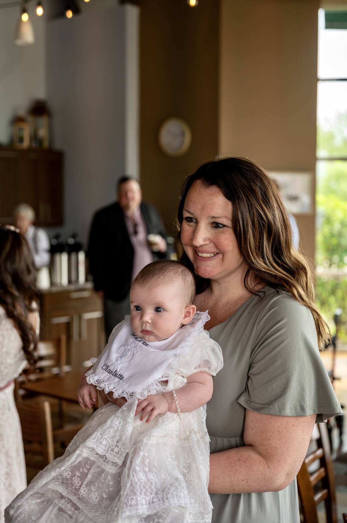 mom-at-church-with-baby-on-baptism-day-2024-11-25-22-30-32-utc