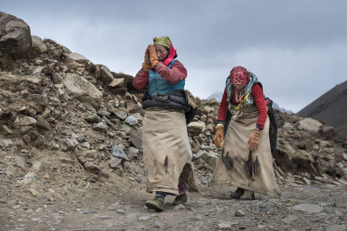 Pilgrims starting on the Kora pilgrimage and prostrating on Mount Kailash; Tibetan Autonomous Region, Tibet
