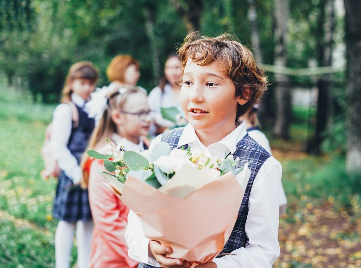 school-boy-with-bouquet-of-flowers-for-teacher-ba-2024-10-23-07-08-28-utc