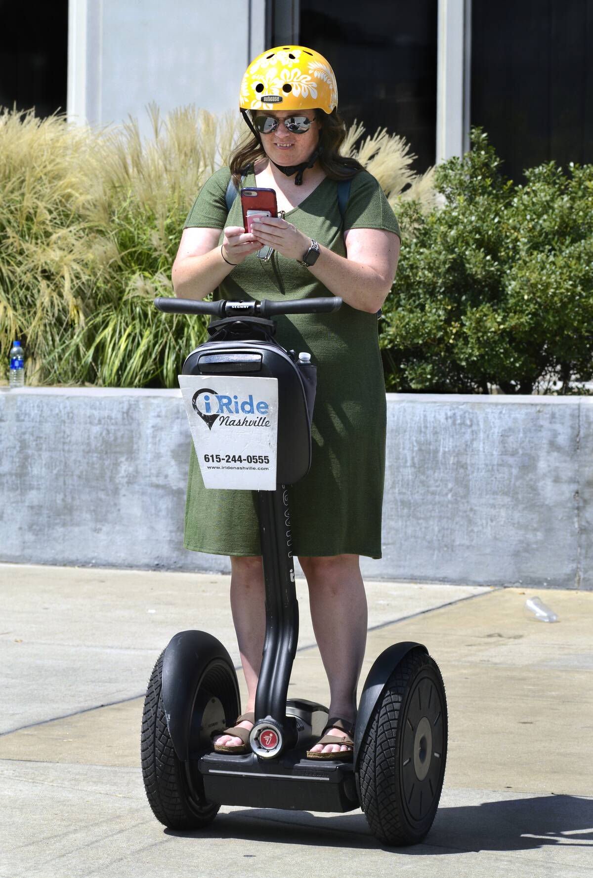 Tourist uses her smartphone while riding a Segway PT