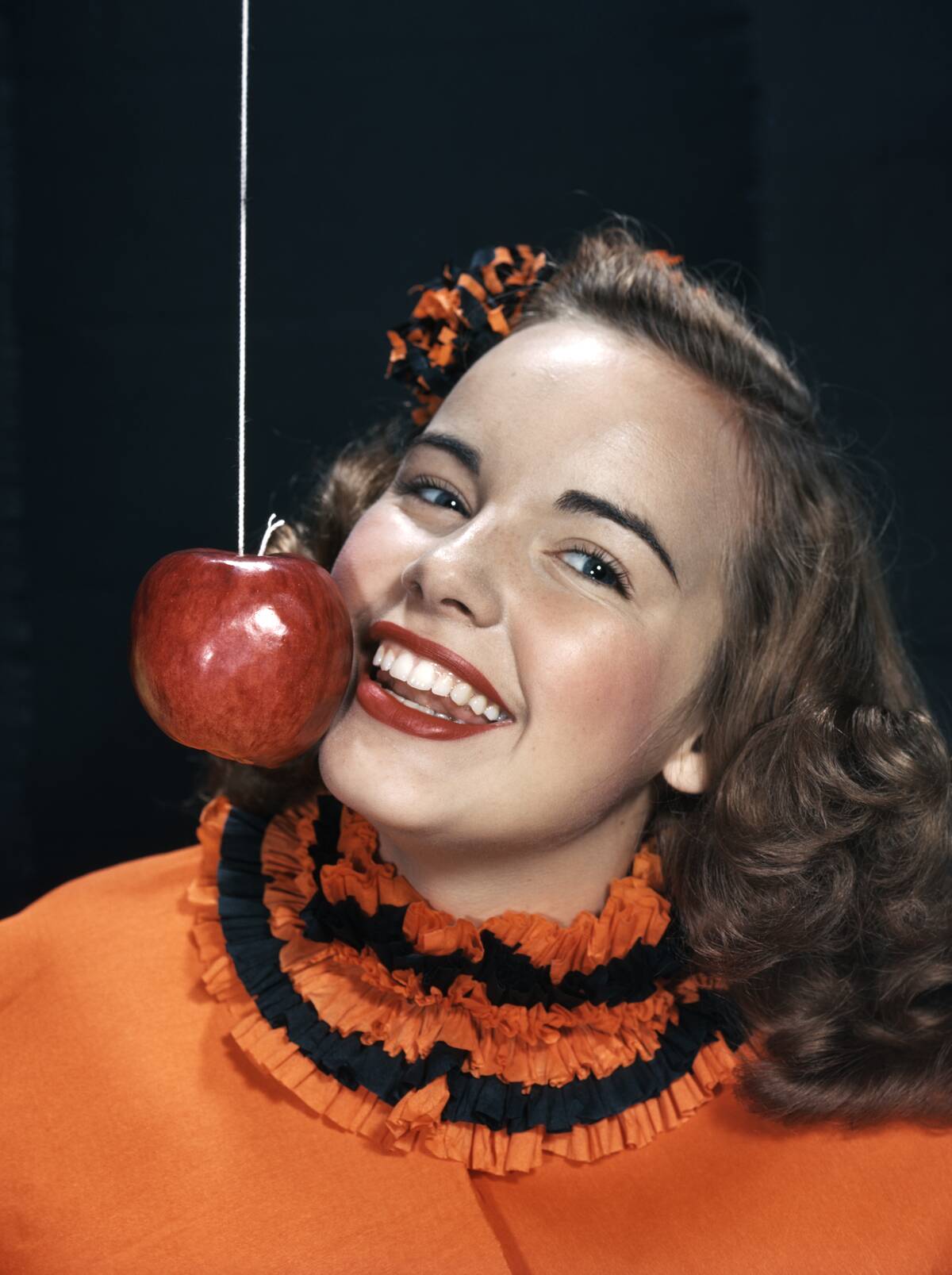 1950's Girl Eating Apple On A String