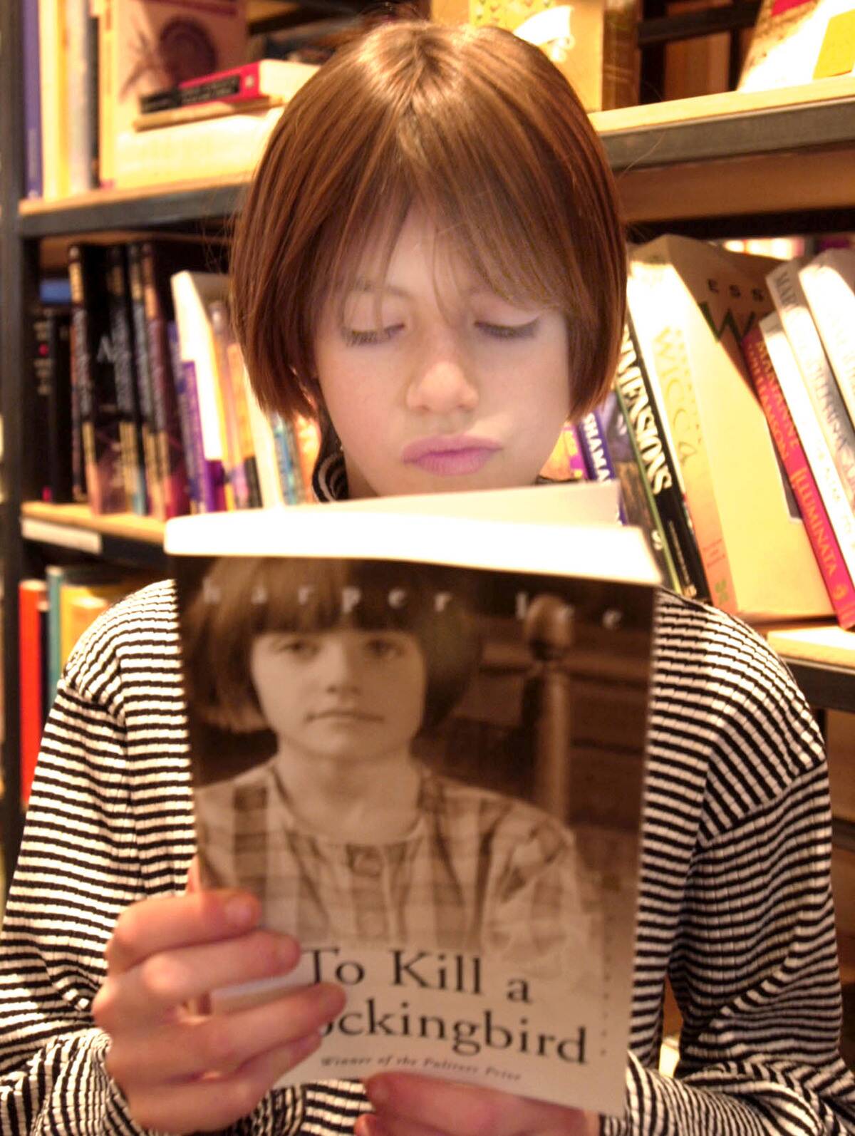 Audrey Seiz, 10, looks at a copy of 'To Kill A Mockingbird' which has a photo of her on the cover at...