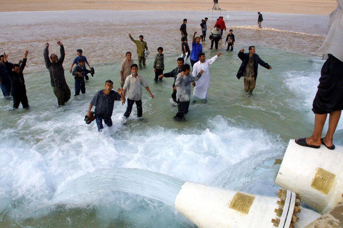 Libyans celebrate as they splash in the waters of