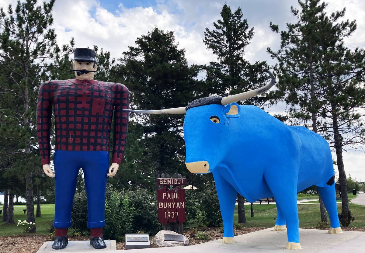 The statues of Paul Bunyan and Babe the Blue Ox stand at...