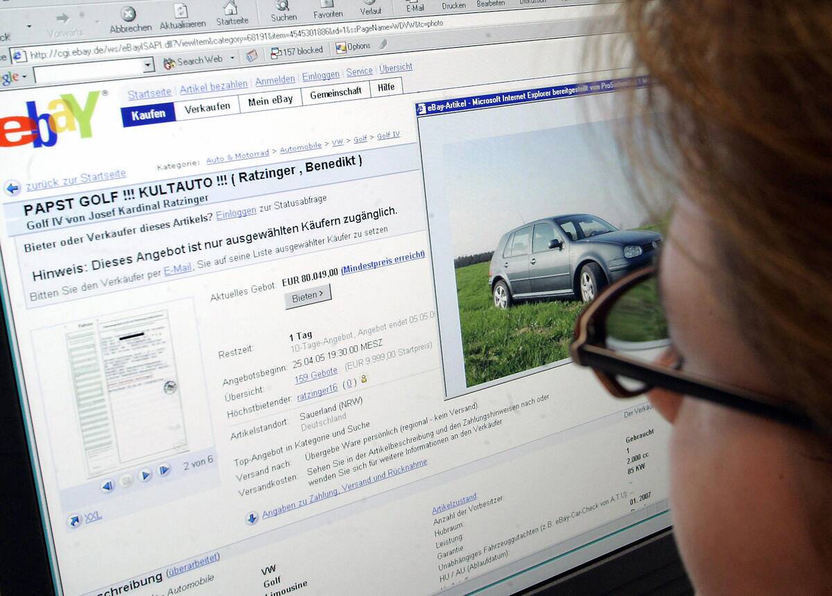 A woman looks on a screen displaying the