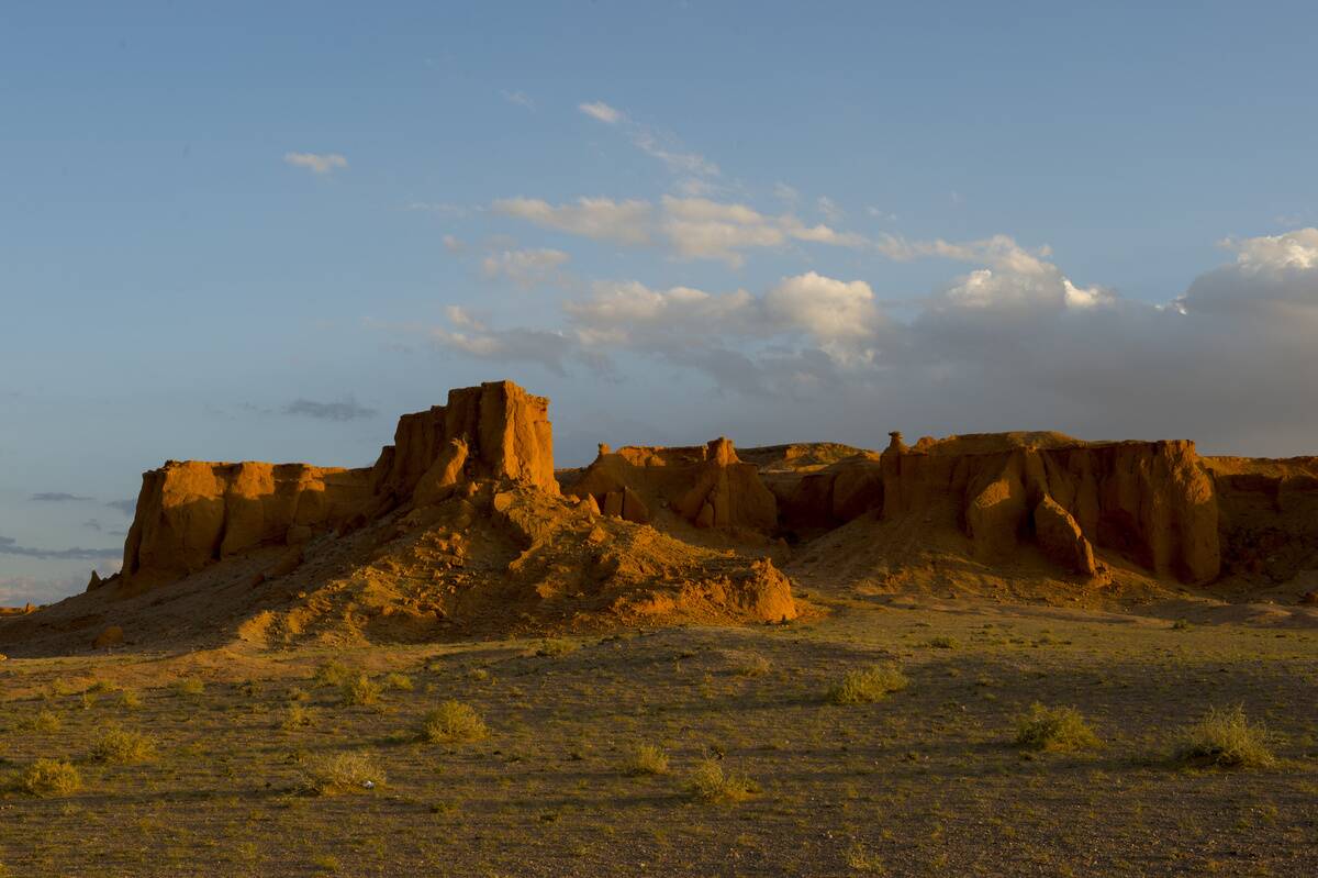 Evening sunshine on the orange rocks of Bayan Zag, commonly...