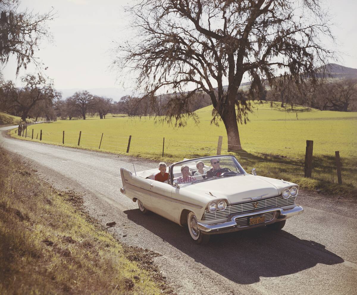 Family drives in car through country road