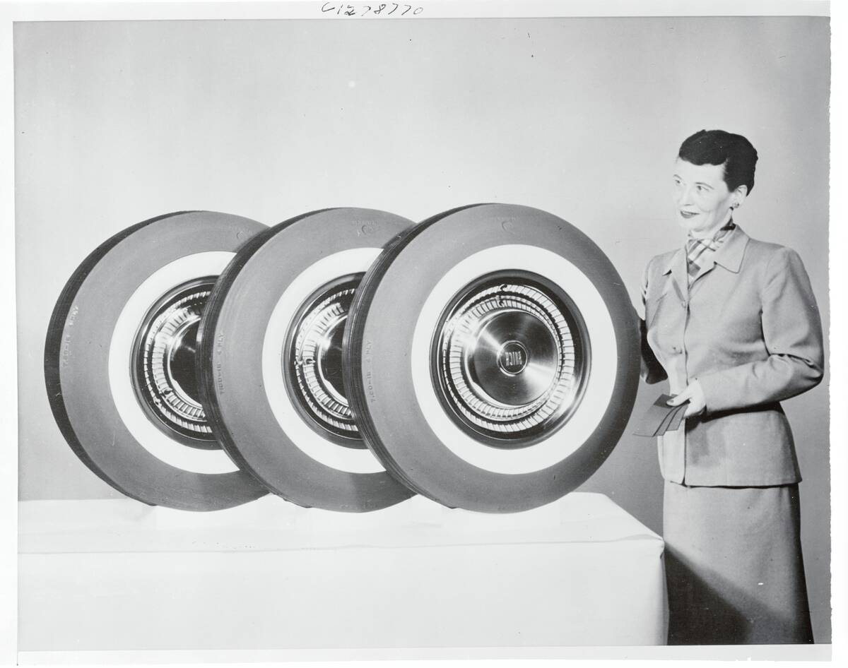 Woman Posing Next to Tires
