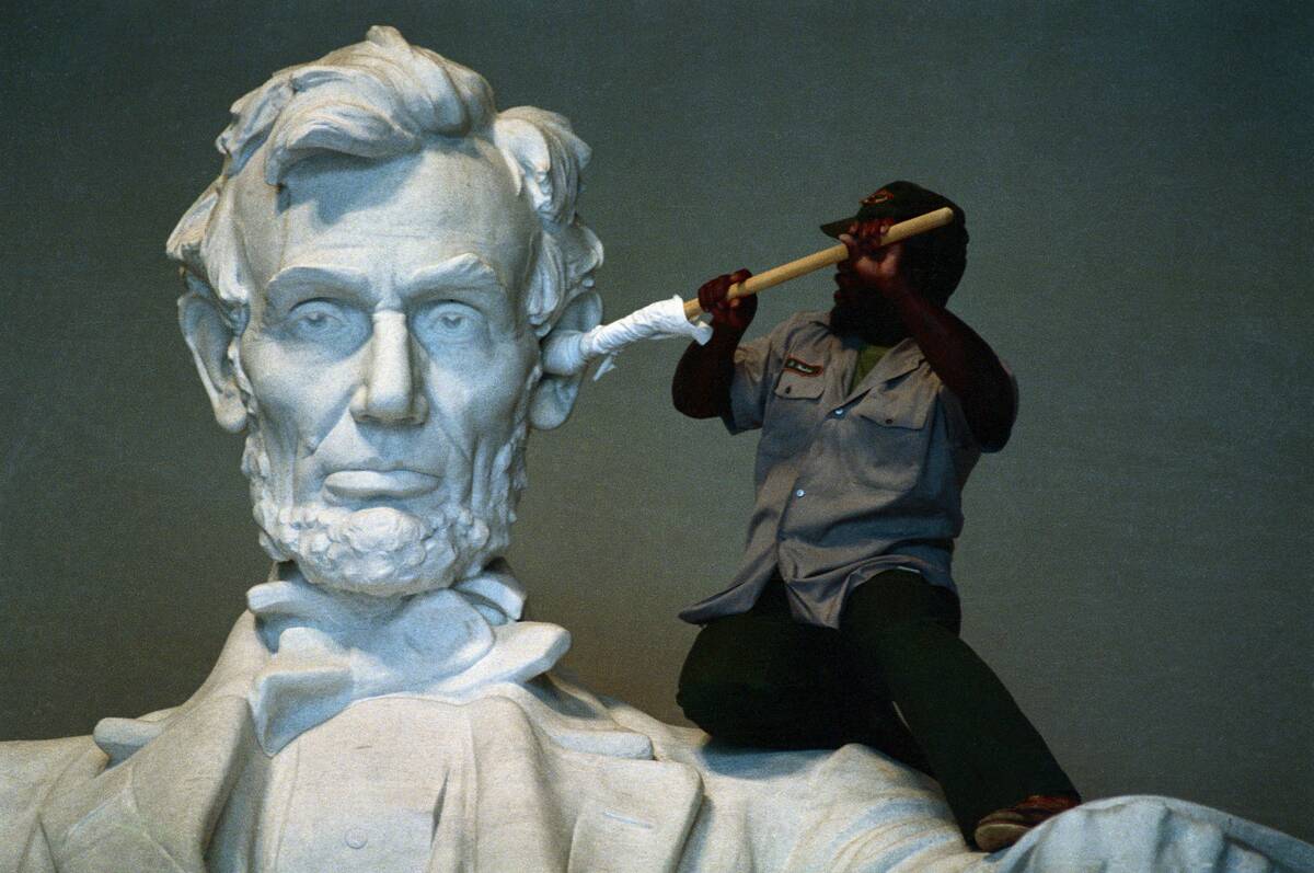 Workman Cleaning Ear of Lincoln by Daniel Chester French in the Lincoln Memorial