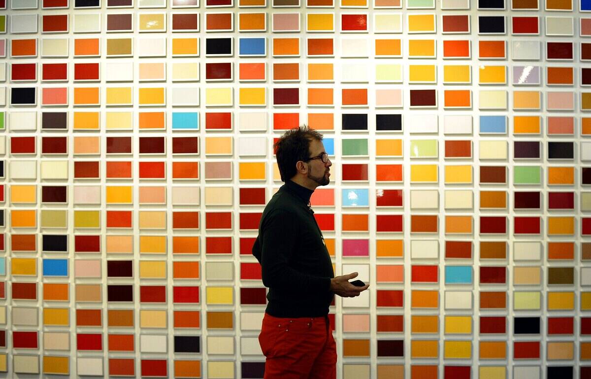 A attendee walks past a sculpture by Em
