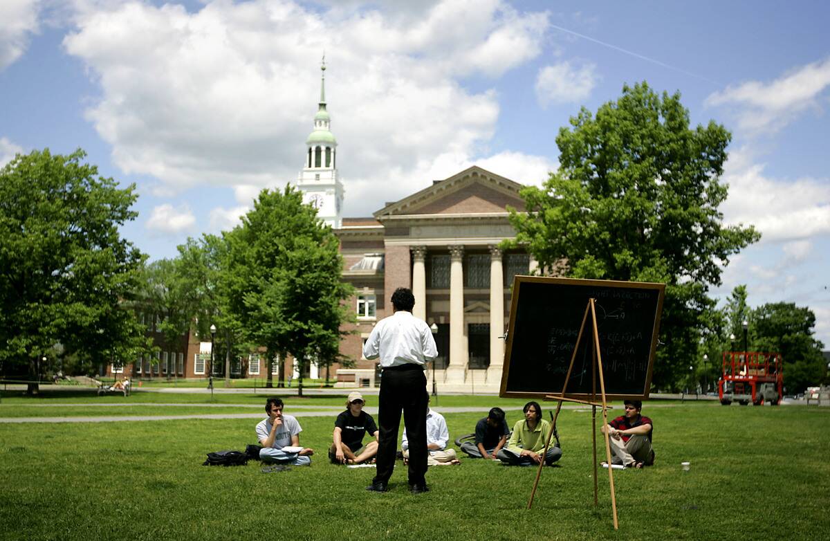 A group of students meet on the lawn outside Webster Hall on