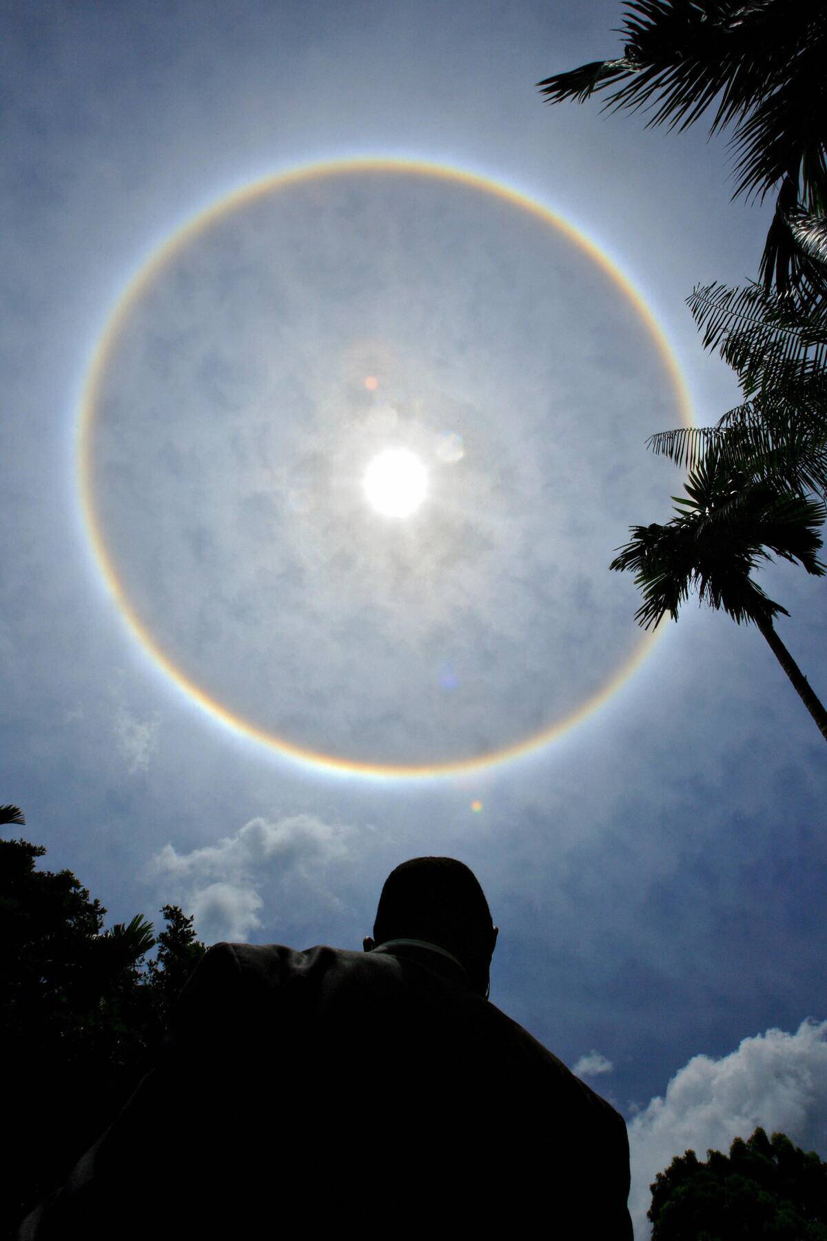 A rare full-circle rainbow surrounds a m