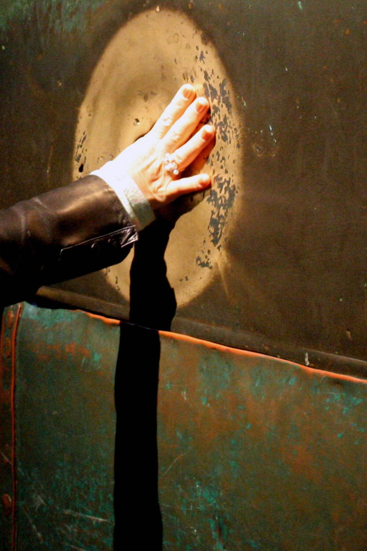 A visitor puts her thumb into the wishin