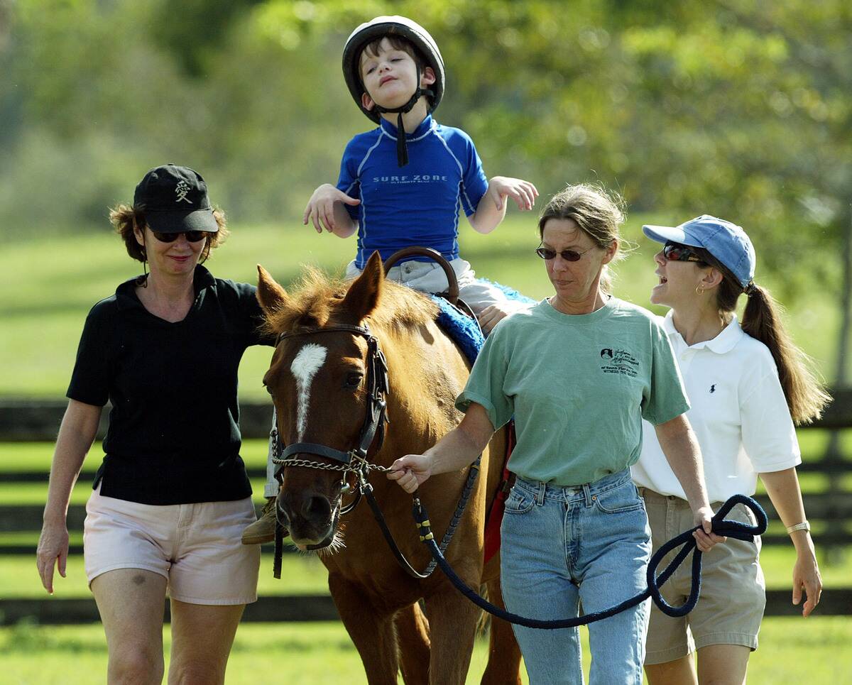 Austistic Boy with Cerebral Palsy Undergoes Horse Therapy