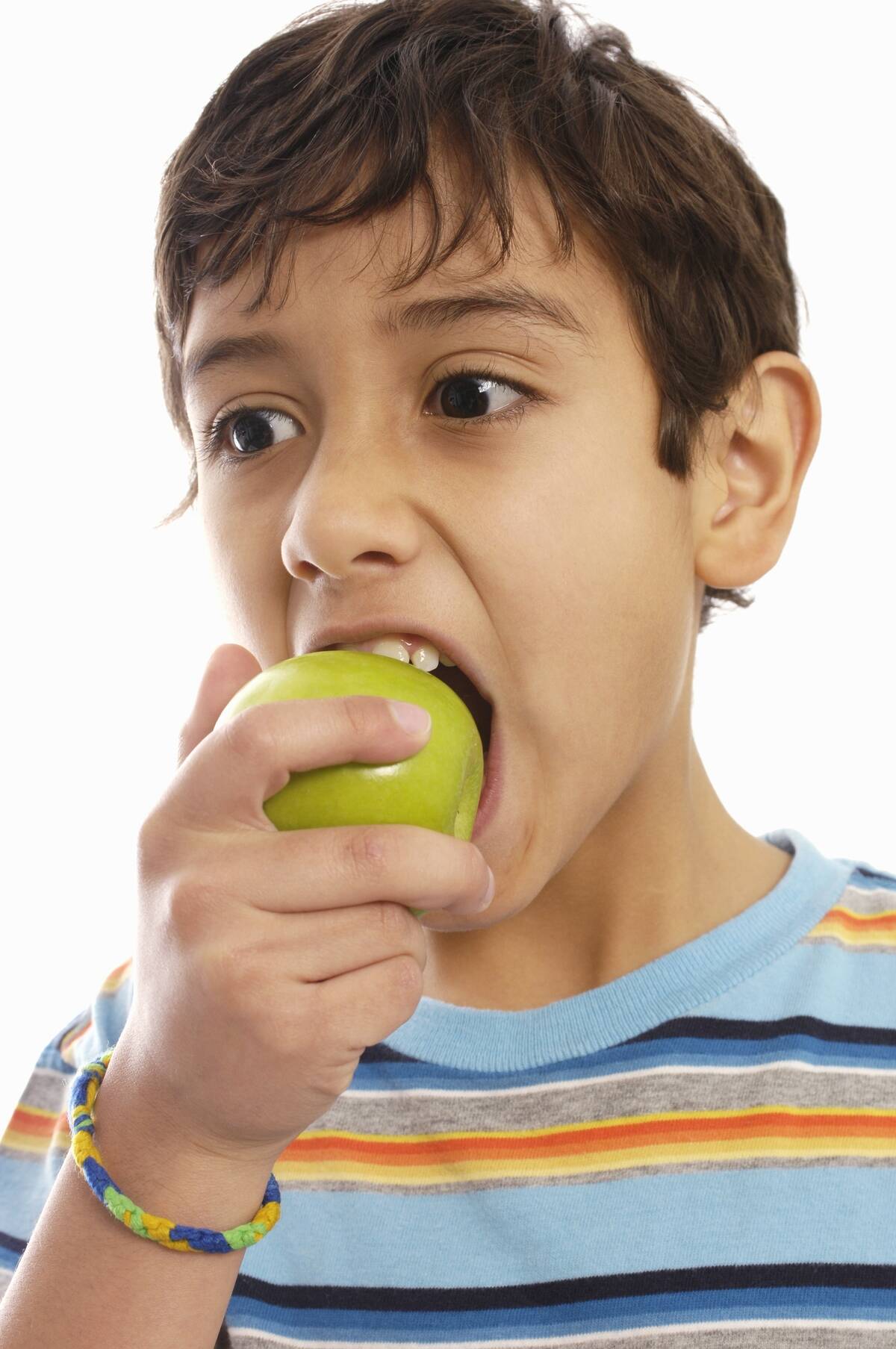 Boy eating green apple