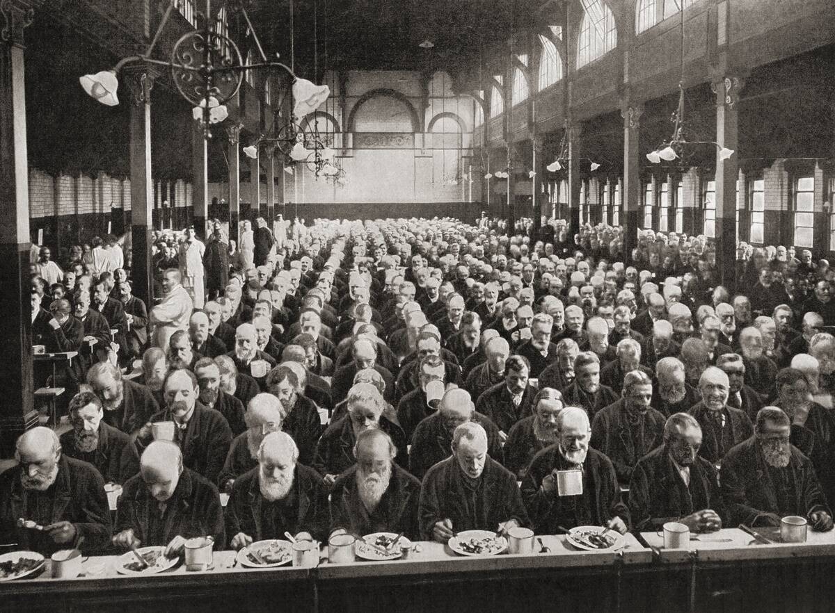 Dinnertime for the inmates of a workhouse, London, England in the late 19th century