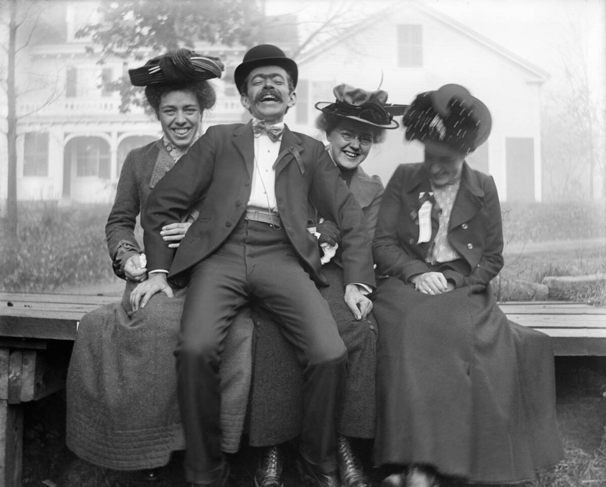 Flirting man with three women, ca. 1900.