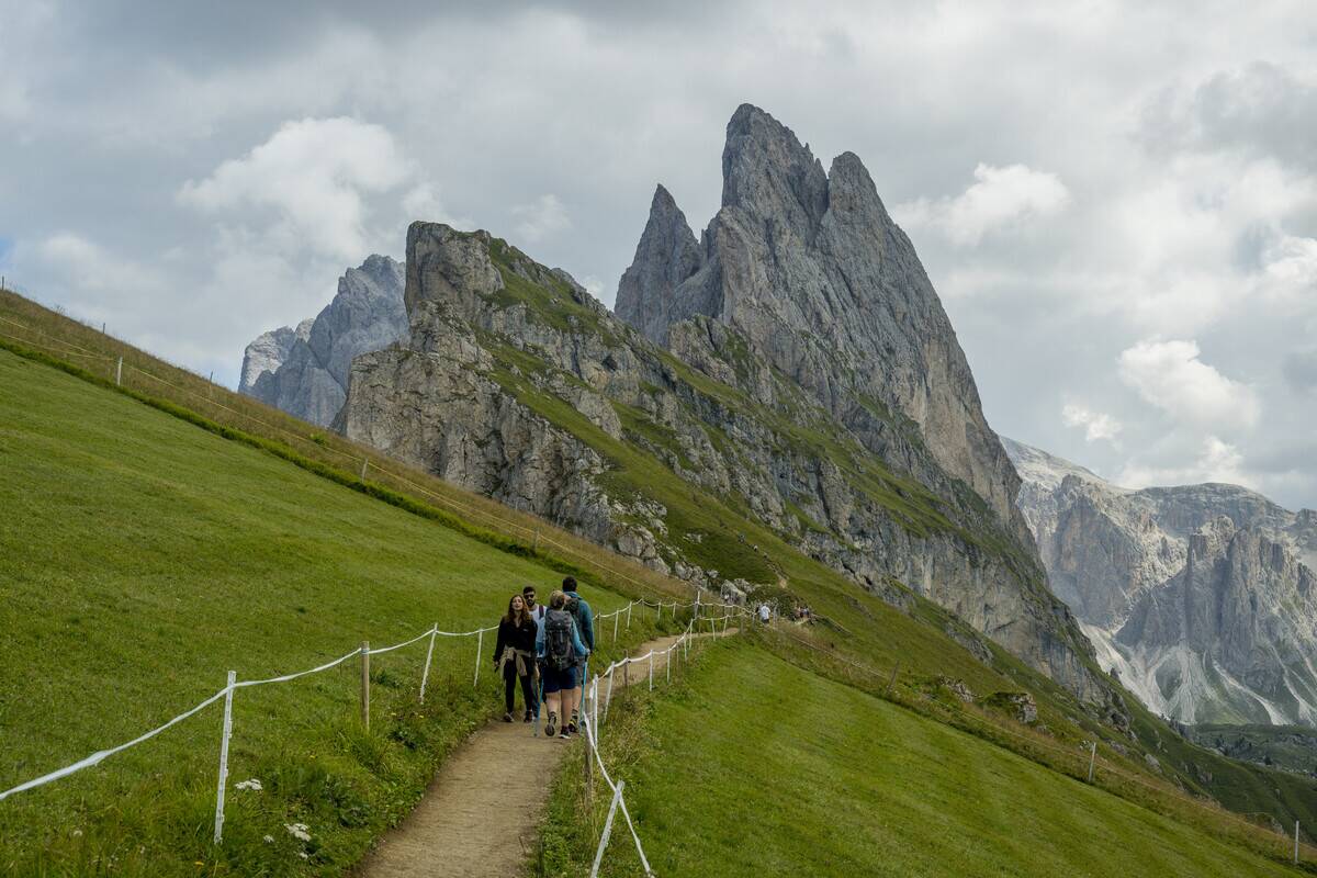 Hikers at Seceda mountain, above Ortisei (Sankt Ulrich) in...