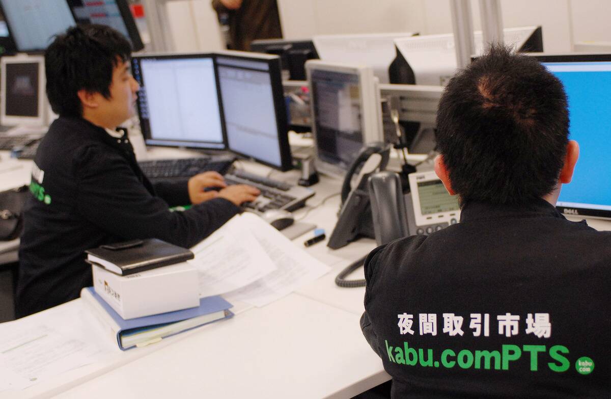Kabu.com Securities Co. staff work at their desks at the com
