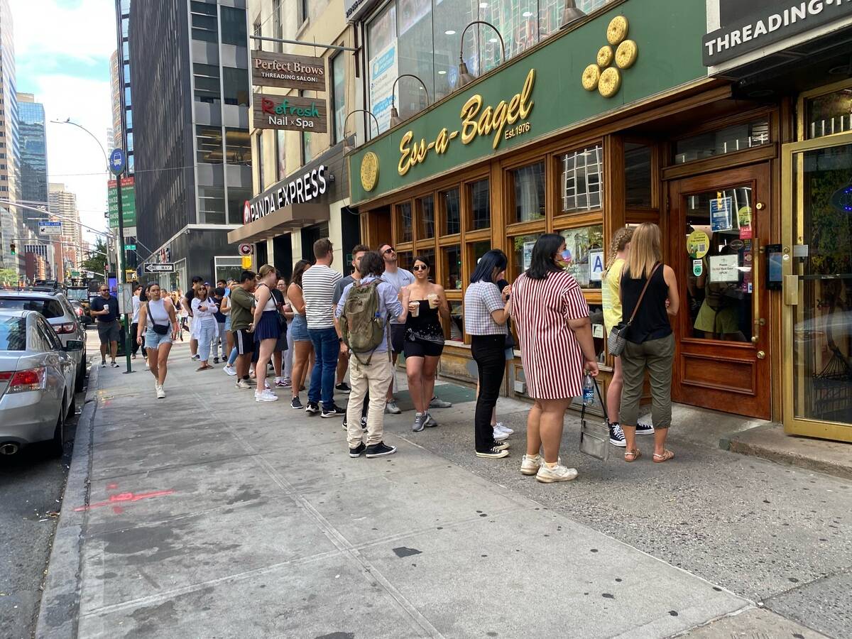 Long line of customers waiting to get into Ess-a-Bagel shop, Manhattan, New York