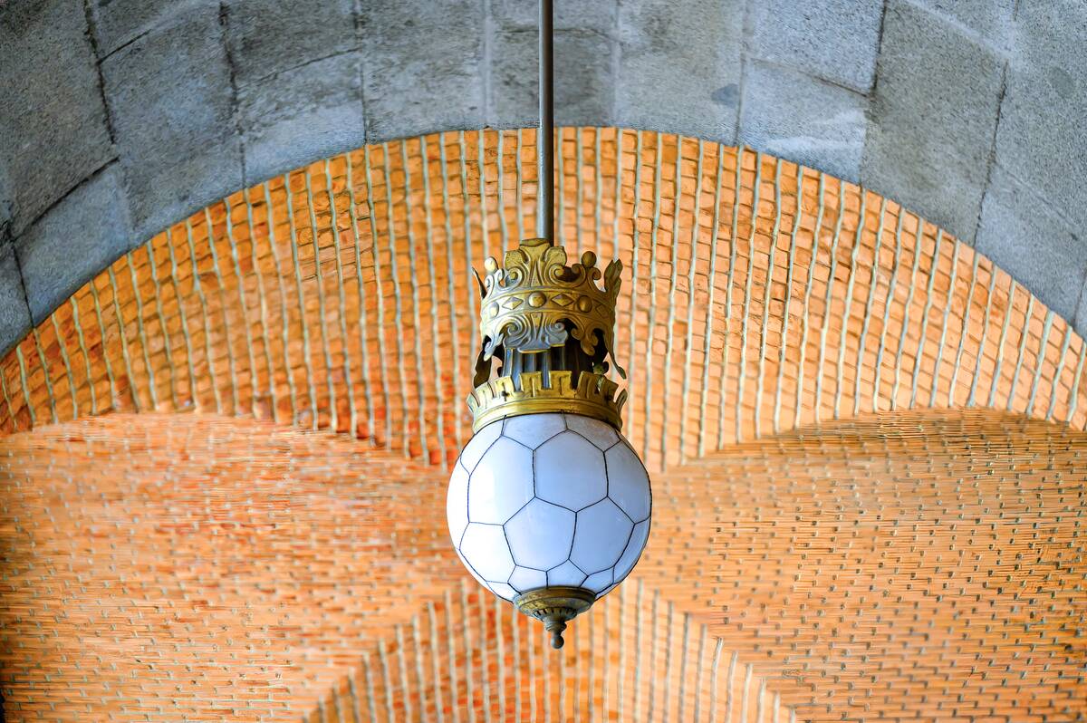 Old-fashioned lamp hanging from the ceiling of an ancient...