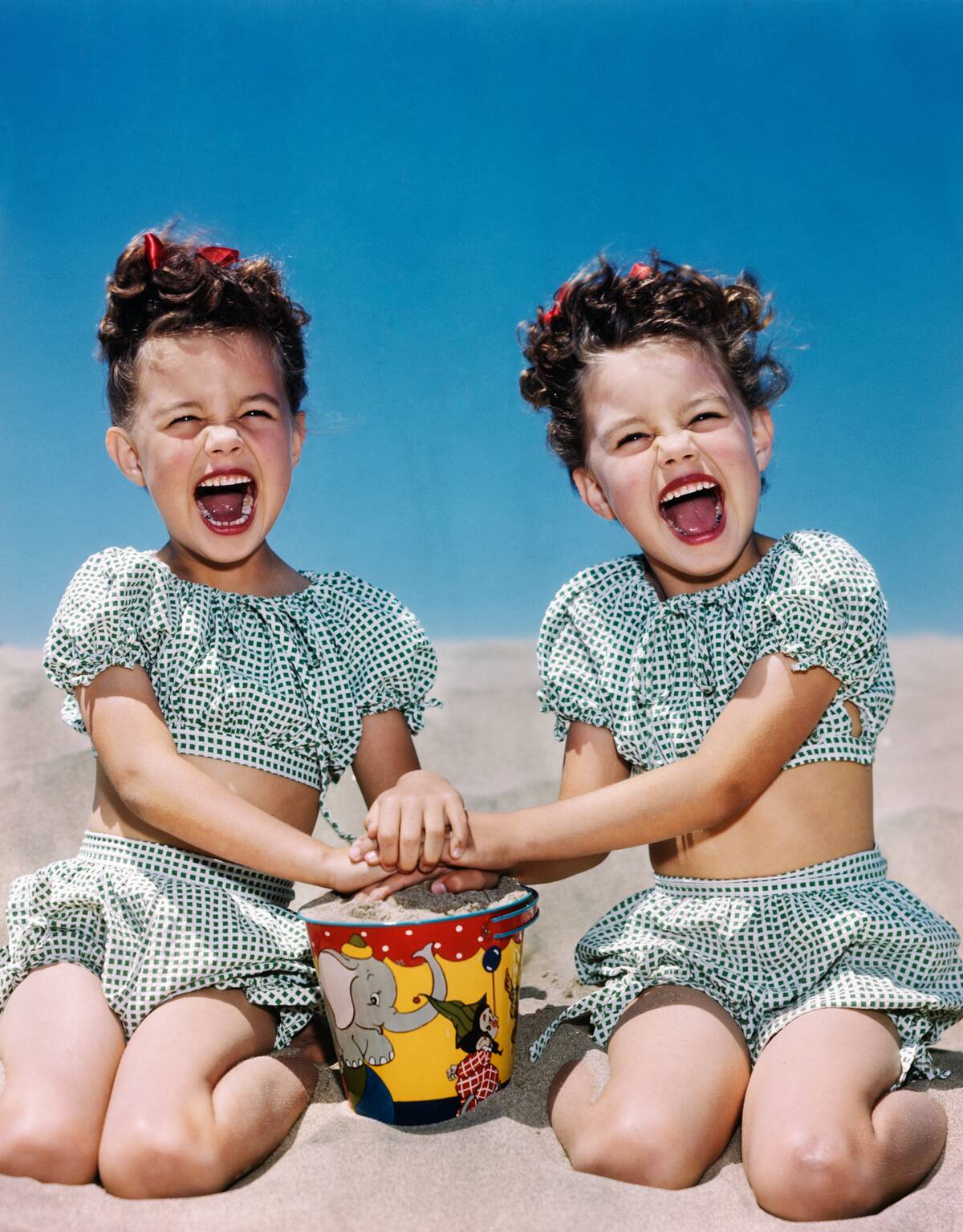 Twin Girls On Beach Playing