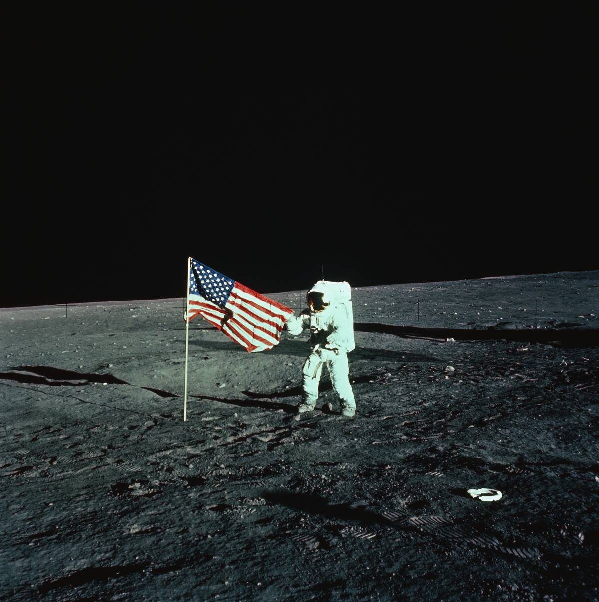 Astronaut Unfurling a United States Flag on the Moon