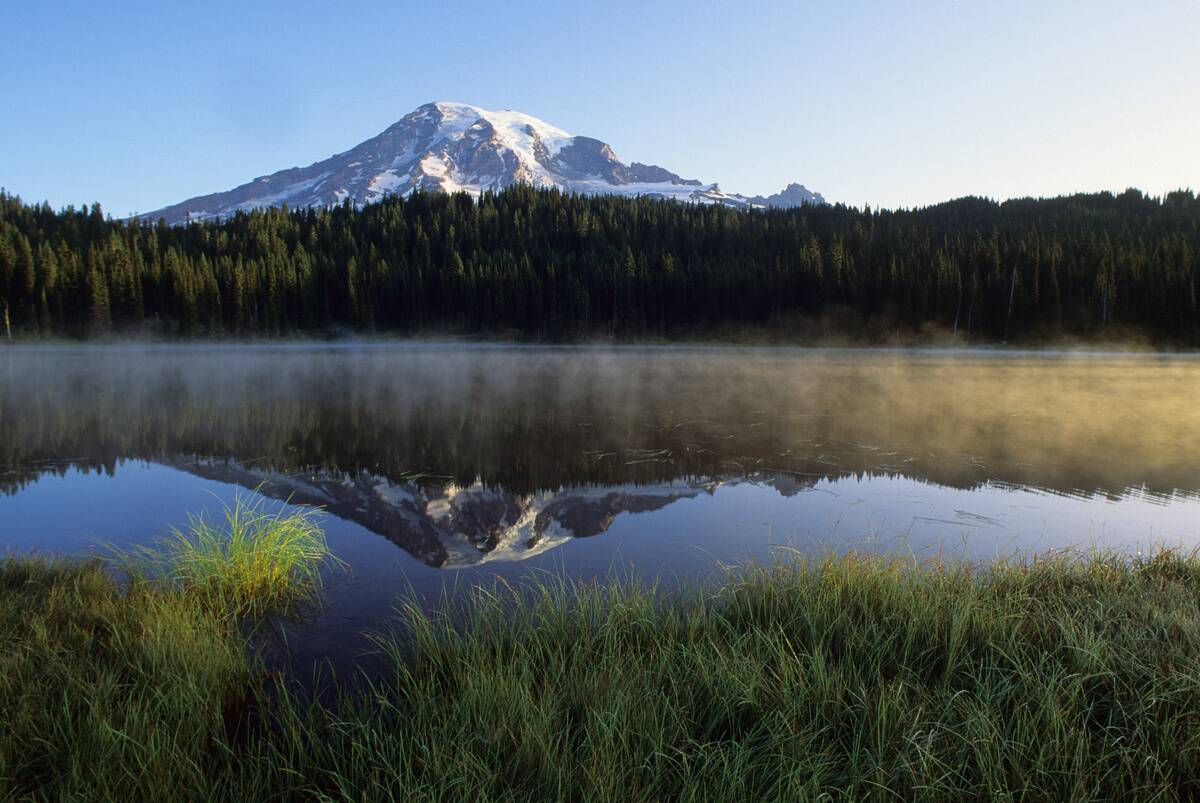 Early morning fog rising from the Reflection Lakes in Mount...