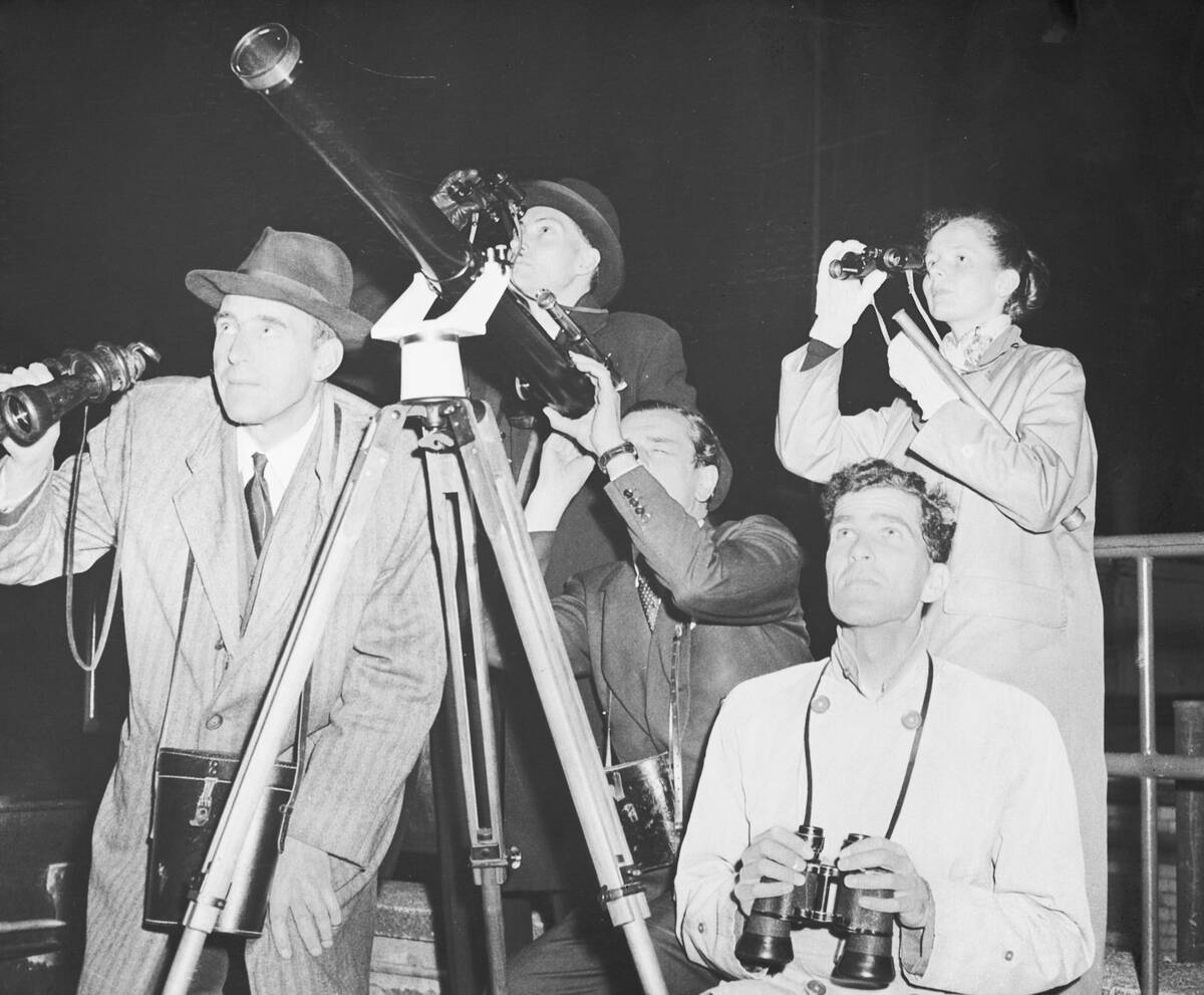 Group Look at Sky with Telescope and Binoculars